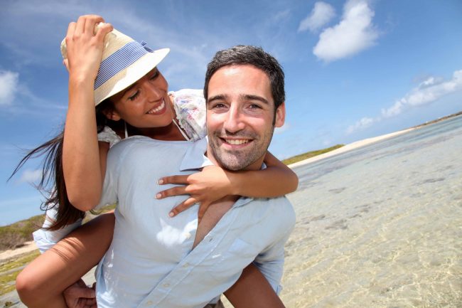 Lovers enjoying sunny day at the beach.