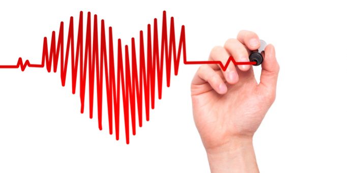 Closeup of hand drawing heart beat in heart shape with stethoscope