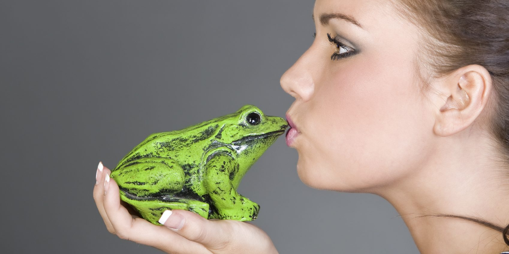 Shot of a Pretty Teen Kissing a Frog
